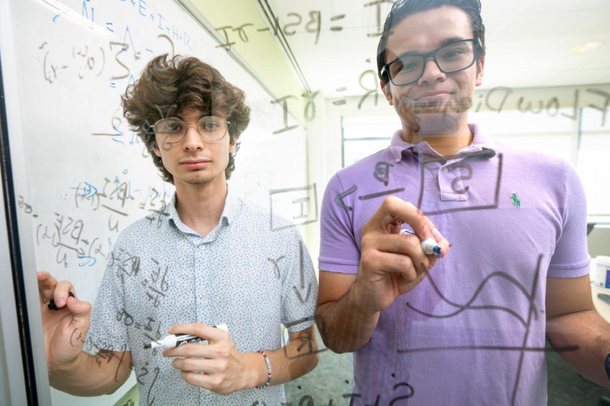 Adan Baca (left) of the University of Arizona and Diego Gonzalez of the University of La Verne worked with mentor Padmanabhan Seshaiyer of George Mason University (GMU) during the inaugural SIAM-Simons Undergraduate Summer Research Program in 2023. While at GMU, Baca and Gonzalez modeled, simulated, and analyzed a patient detox journey by treating addiction as an infectious disease. Photo courtesy of Evan Cantwell.