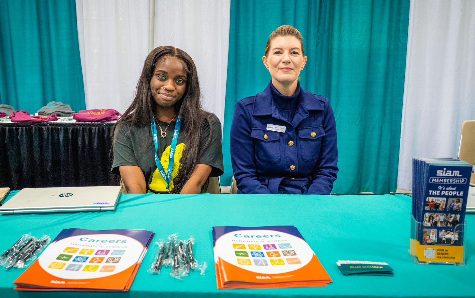 SIAM Student Member Coordinator Jurnee Jessie (left) and SIAM Membership Manager Paula White staff the membership booth at the 2025 SIAM Conference on Computational Science and Engineering, which took place last March in Fort Worth, Texas. SIAM photo.