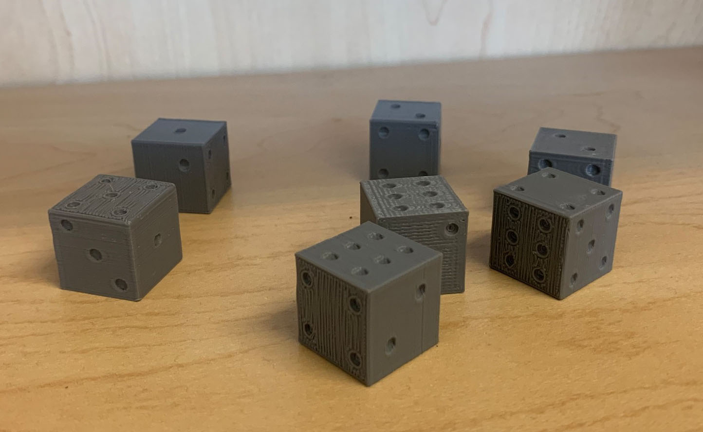 &lt;strong&gt;Figure 2.&lt;/strong&gt; Seven weighted six-sided dice that were fabricated with a 3D printer. Figure courtesy of Jake Price.