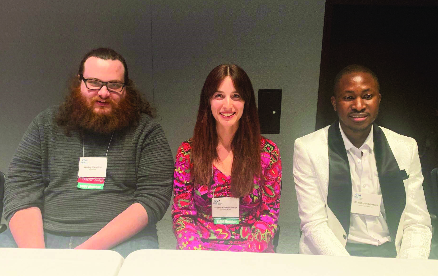 During the SIAM-sponsored “Session on Education as Research and Research as Education” at the 2023 Joint Mathematics Meetings (JMM23), which took place in Boston, Mass., in January, a panel discussion explored the different aspects of integrating research with teaching. From left to right: panelists Wesley Hamilton (MathWorks), Rebecca Hardenbrook (University of Utah), and Tosin Babasola (University of Bath). Photo courtesy of Kathleen Kavanagh.