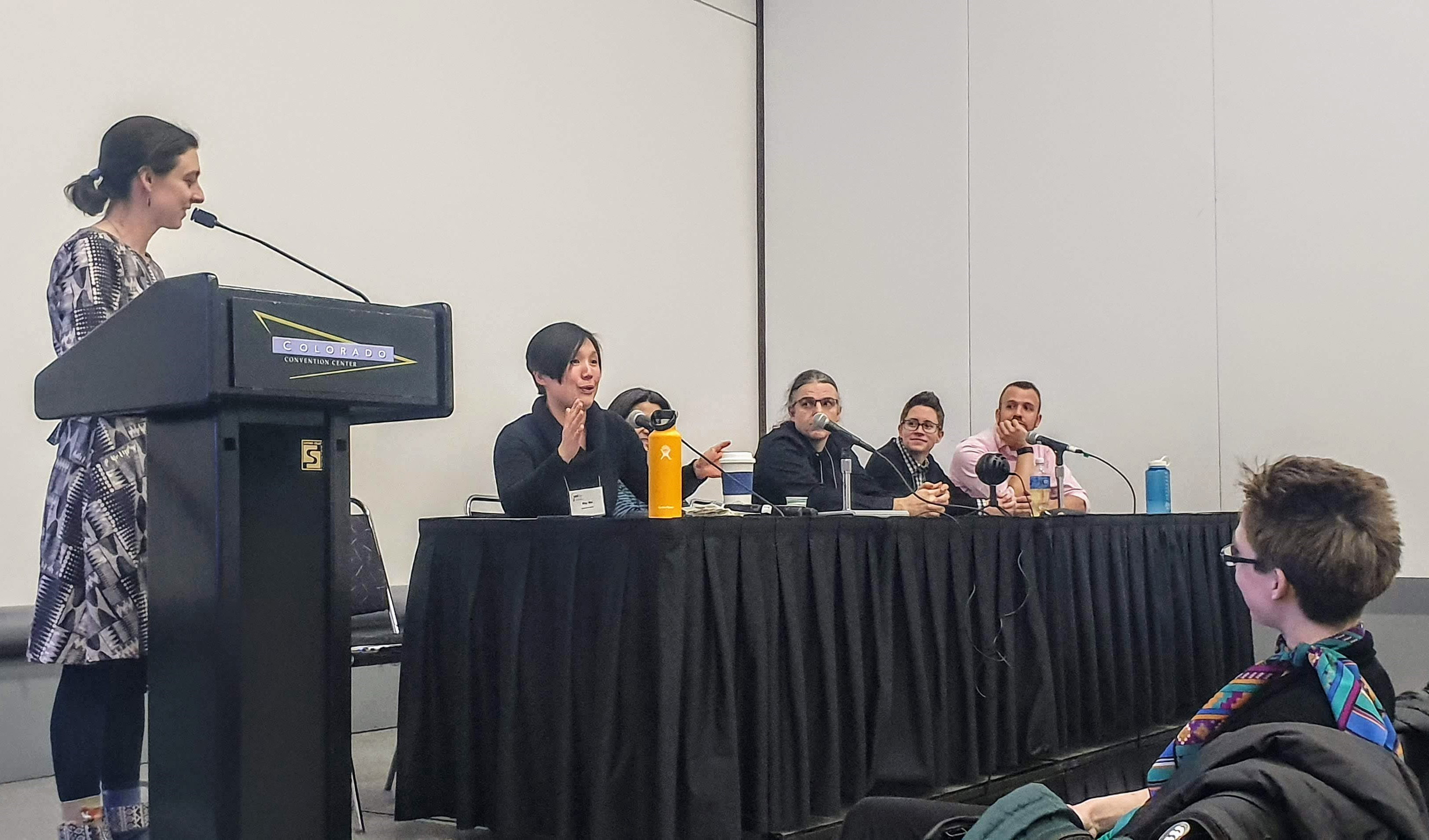 Spectra hosted a joint panel with the Association for Women in Mathematics on “Queer Families and Mathematical Careers” at the 2020 Joint Mathematics Meetings, which took place in January 2020 in Denver, Colo. From left to right: Moderator Alice Mark and panelists May Mei, Chikako Mese, Dylan Thurston, Amanda Folsom, and Matt Voigt, with co-organizer Corrin Clarkson seated in the foreground. Photo courtesy of Alexander Hoover.