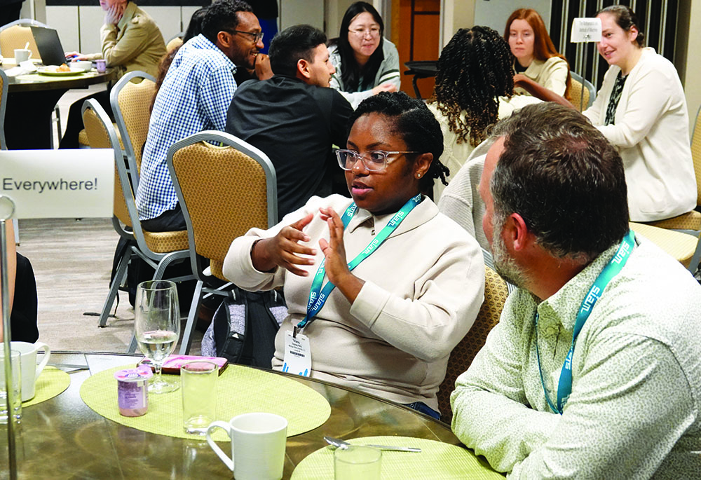 Broader Engagement (BE) participants and Guided Affinity Group (GAG) leaders converse during a GAG breakfast as part of the BE program at the 2024 SIAM Conference on Mathematics of Data Science, which took place in Atlanta, Ga., last October. Photo courtesy of David Brown.