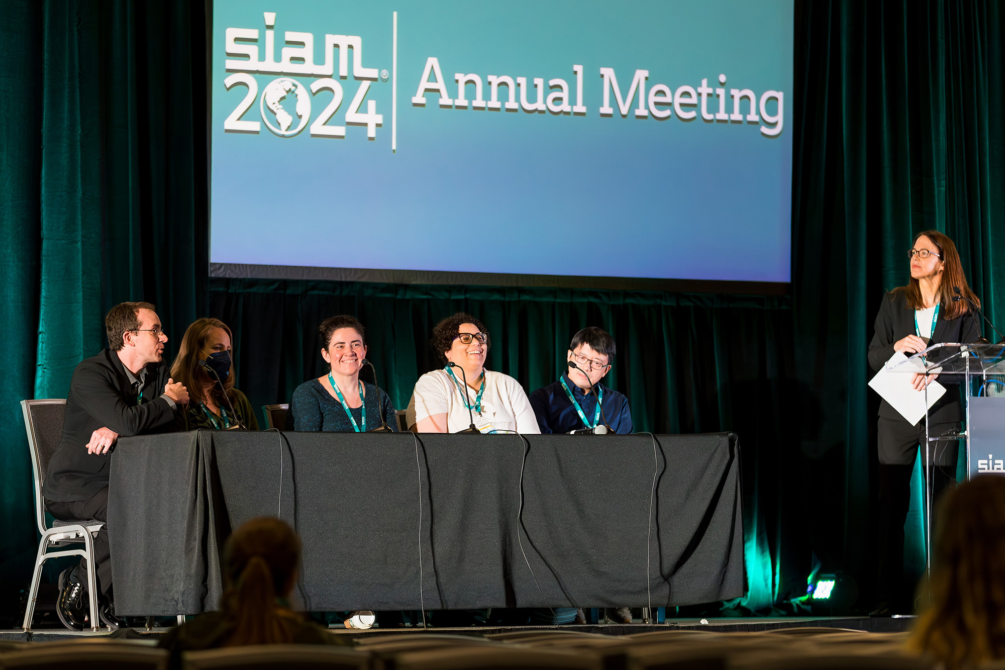 A career panel at the 2024 SIAM Annual Meeting, which was held this July in Spokane, Wash., explored mathematical research in industry and the national laboratories. From left to right: panelists John-Paul Sabino (The Boeing Company), Amanda Howard (Pacific Northwest National Laboratory), Gwen Spencer (Netflix), Nicole Jackson (Sandia National Laboratories), and Wotao Yin (Alibaba Group/Academy for Discovery, Adventure, Momentum and Outlook), as well as moderator Sharon Arroyo (The Boeing Company). SIAM photo.