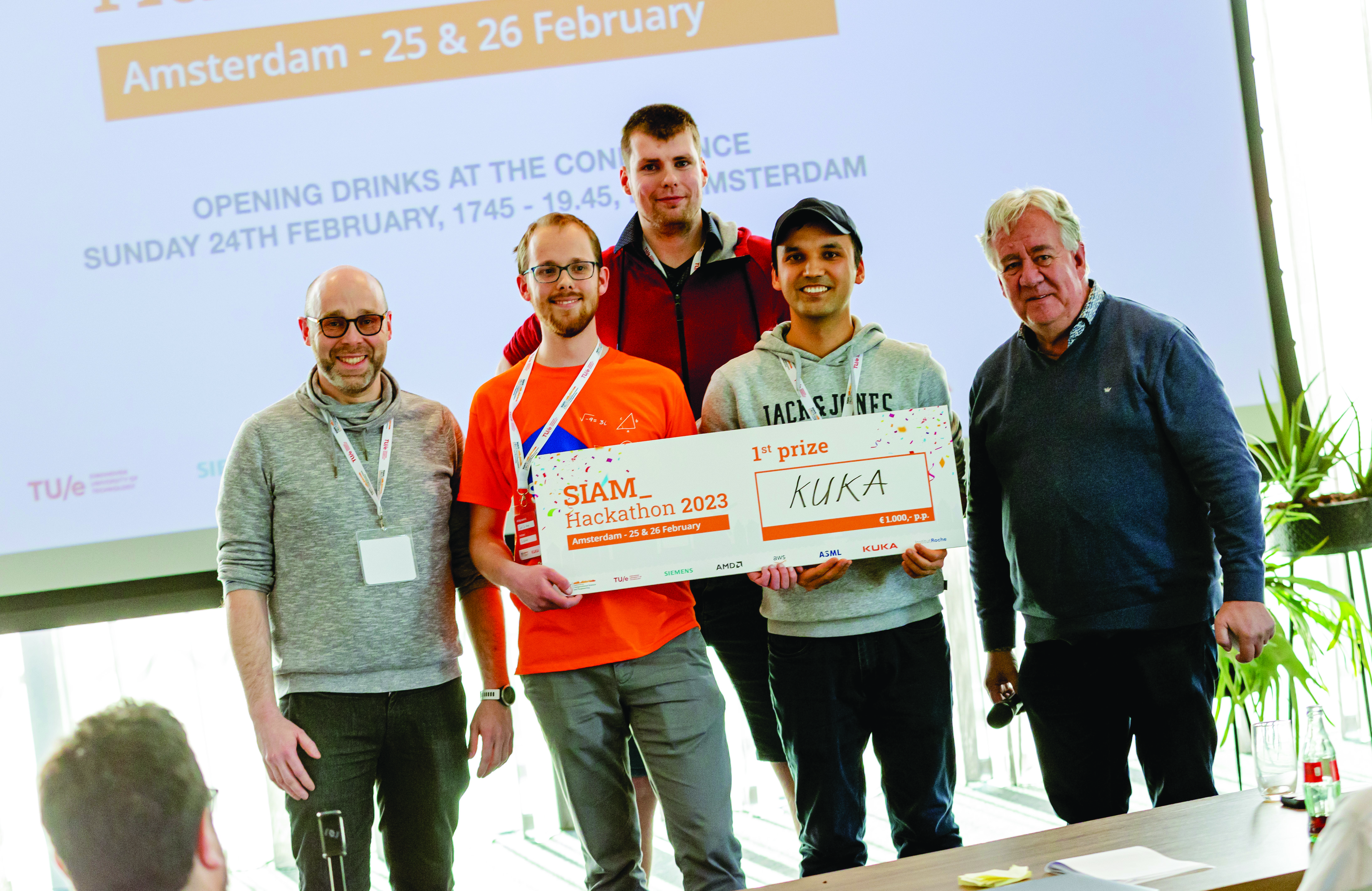 Members of the winning team of the SIAM Hackathon—which took place just before the 2023 SIAM Conference on Computational Science and Engineering (CSE23) in Amsterdam, the Netherlands—pose after successfully presenting their final pitch on February 26. From left to right: Daniel Fink (challenge organizer from KUKA), Tjeerd Jan Heeringa (University of Twente), Wouter van Harten (Radboud University), Ikrom Akramov (Technical University of Hamburg), and Wil Schilders (Eindhoven University of Technology and Organizing Committee co-chair of CSE23). SIAM photo.