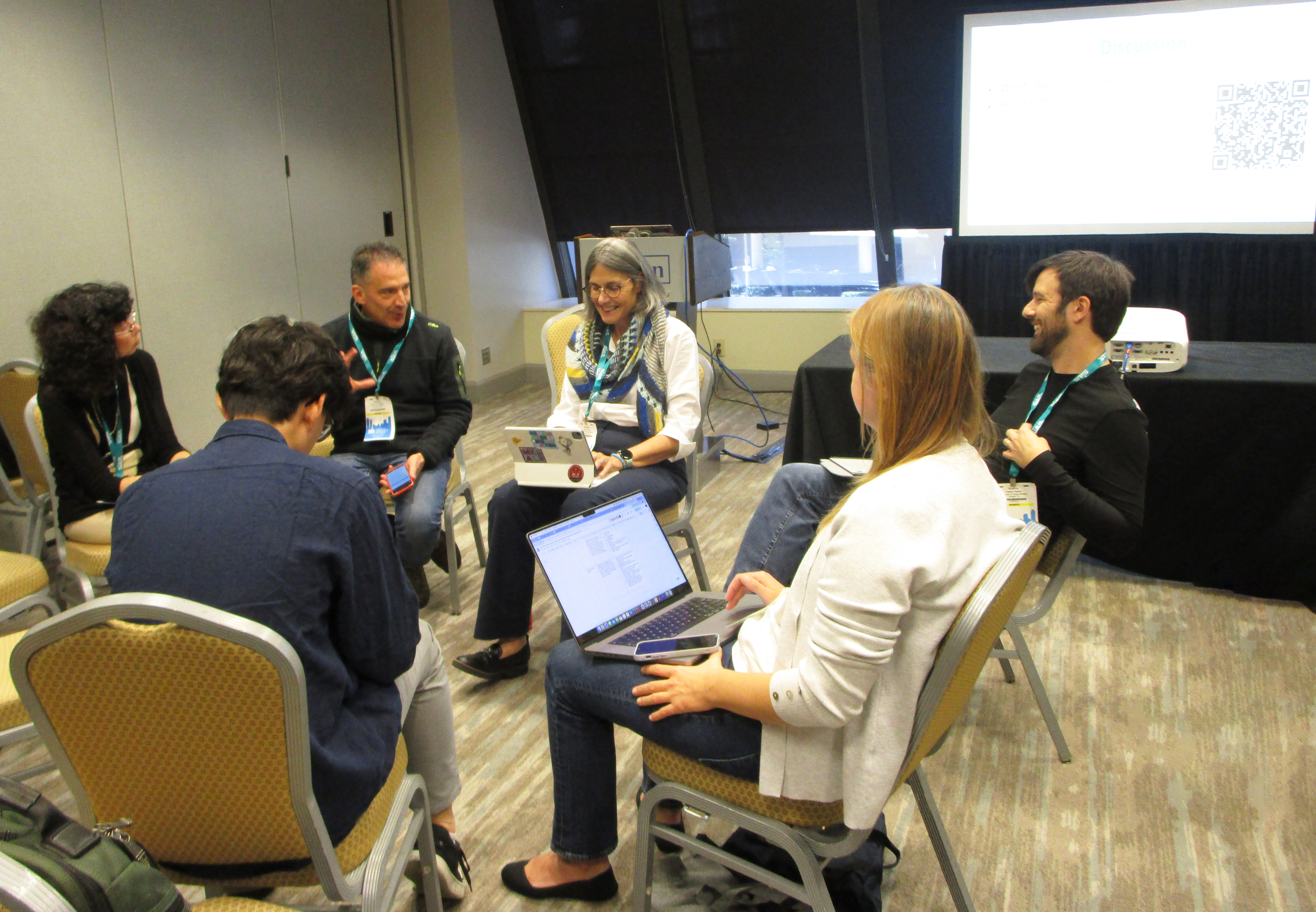 During the 2024 SIAM Conference on Mathematics of Data Science, members of a multidisciplinary data science task brainstorm ideas with session attendees.