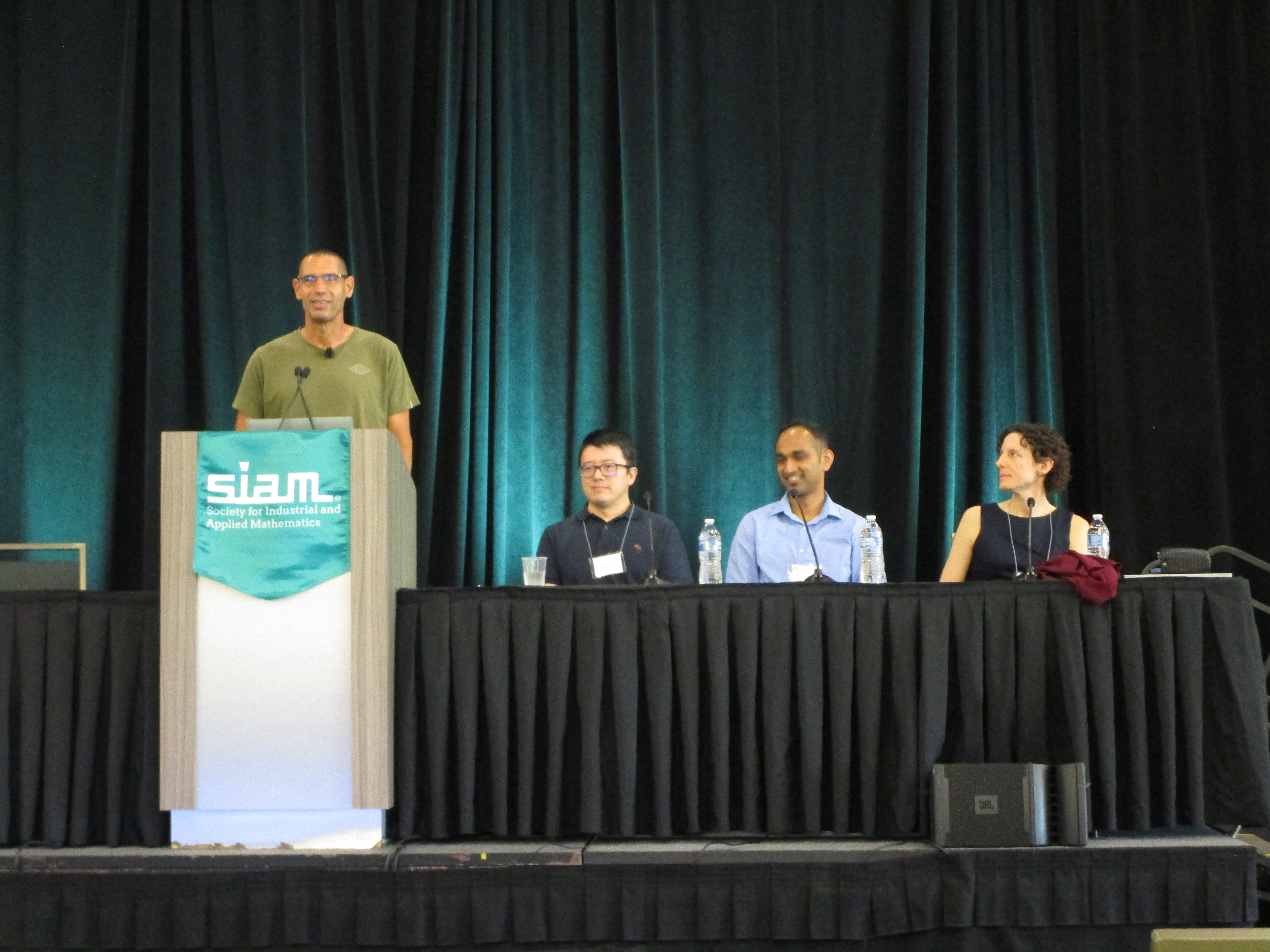 A panel of industry researchers at the 2022 SIAM Conference on Mathematics of Data Science, which took place in San Diego, Calif., this September, addressed the complex yet mutually beneficial relationship between academia and industry. From left to right: moderator Eldad Haber (University of British Columbia) engages panelists Wotao Yin (Alibaba Group/Academy for Discovery, Adventure, Momentum and Outlook), Shashanka Ubaru (IBM Research), and Dawn Woodard (LinkedIn) in conversation. SIAM photo.