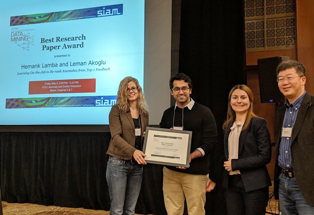 Hemank Lamba (second from left) and Leman Akoglu (third from left) of Carnegie Mellon University receive the Best Research Paper Award from Conference Program Co-chairs Jennifer Neville (Purdue University) and Xifeng Yan (University of California, Santa Barbara) at the <a href="https://www.siam.org/conferences-events/past-event-archive/sdm19/"> 2019 SIAM International Conference on Data Mining</a>, which took place in Calgary, Alberta, Canada in early May. Their paper and presentation were titled <a href=https://meetings.siam.org/sess/dsp_talk.cfm?p=100565>" “Learning On-the-Job to Re-Rank Anomalies from Top-1 Feedback.” </a> Photo courtesy of Tanya Berger-Wolf.