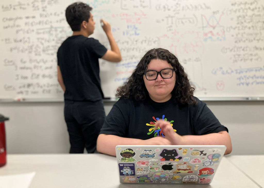 Mia Escobar of the University of Washington Tacoma and her research partner, Valentin Garcia of Brown University (rear), studied perfect state transfer and early state exclusion in quantum spin chains at the University of Hartford this past summer. The two took part in the 2025 SIAM-Simons Undergraduate Summer Research Program, which provides funding for undergraduate students to conduct eight weeks of research at various institutions across the U.S. Photo courtesy of the author.