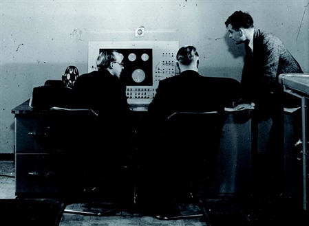 Alan Turing with two colleagues and the Ferranti Mark I computer, January 1951. Photo courtesy of the University of Manchester.