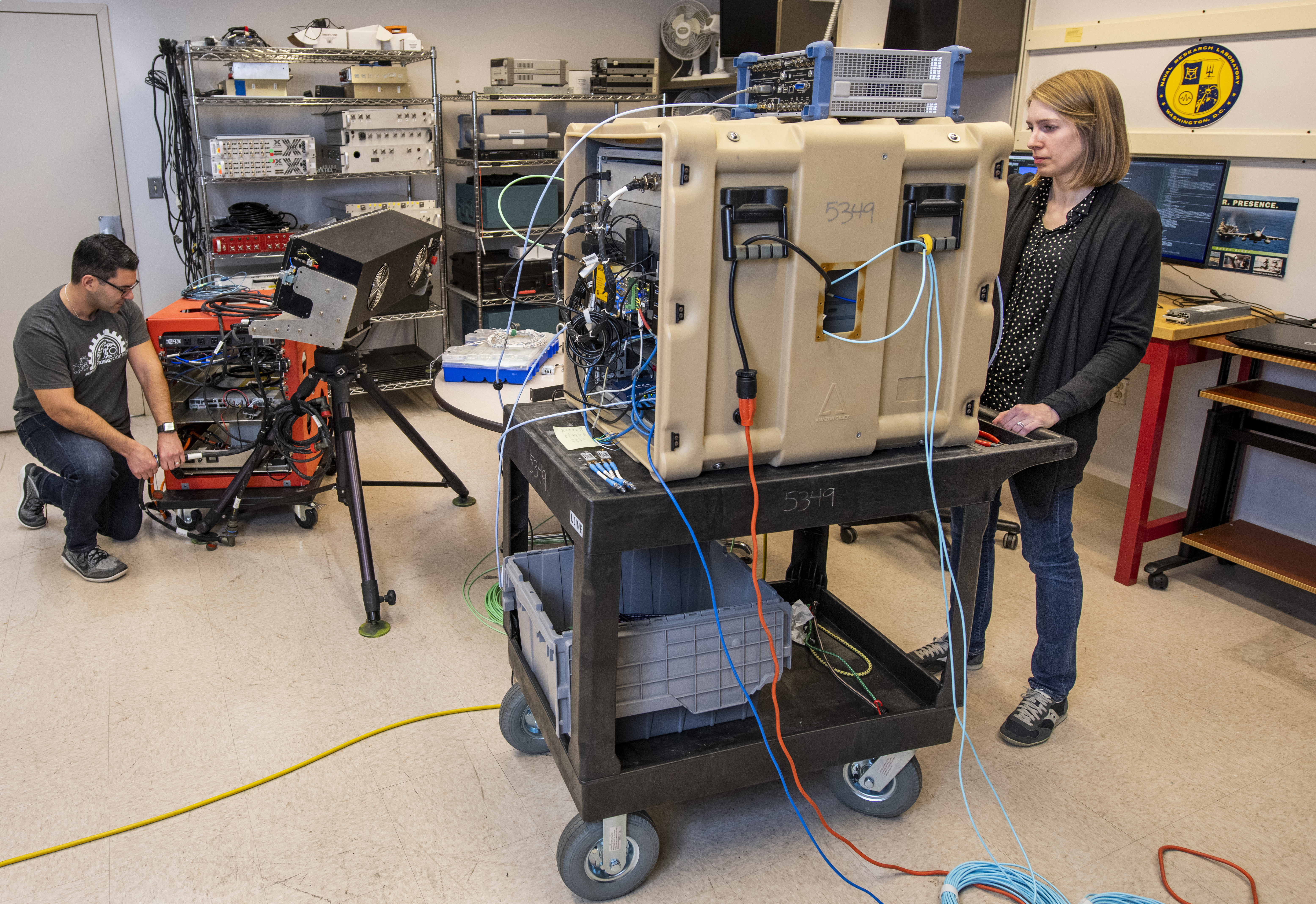 U.S. Naval Research Laboratory (NRL) mathematician Tegan Webster (right) and NRL electrical engineer Marc Schneider prepare the Multichannel Active Electronically Scanned Array (MAESA) radar testbed for data collection. MAESA handles and visualizes data for research and development in radar technology. U.S. Navy photo courtesy of Sarah Peterson.