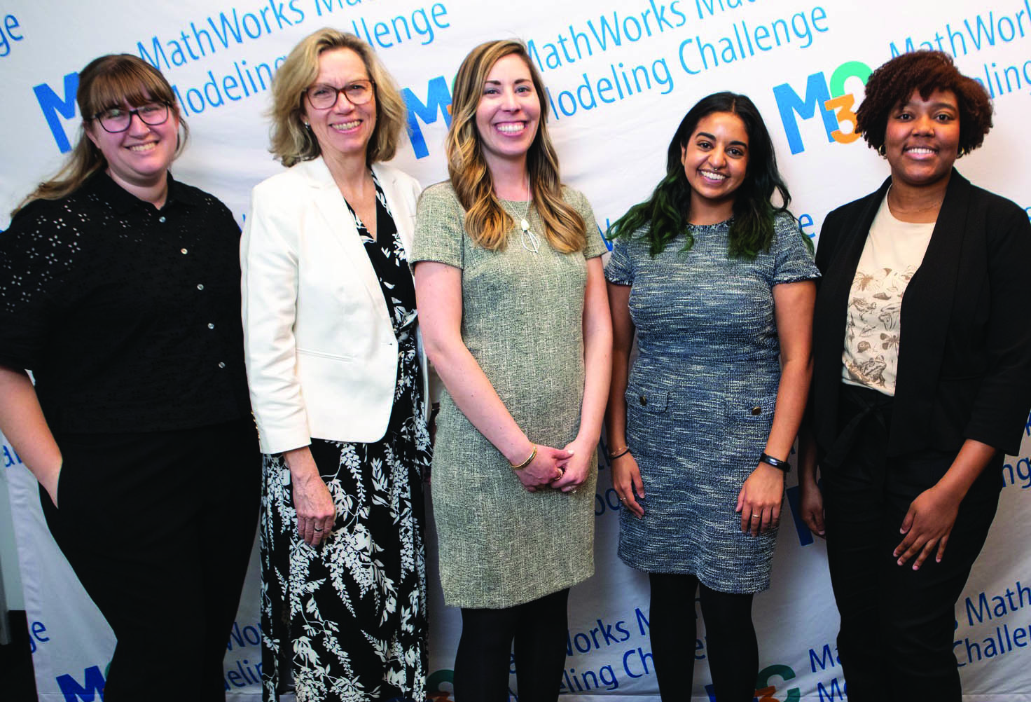 SIAM staff pose at the 2022 MathWorks Math Modeling Challenge (M3 Challenge) Final Event, which took place in New York City in April 2022. From left to right: Eliana Zimet, Programs Coordinator; Michelle Montgomery, M3 Challenge Project Director; Becky Kerner, Director of Marketing and Communications; Adrianne Ali, Marketing and Communications Manager; and Taylor Johnson, Digital Communications and Content Coordinator. SIAM photo.