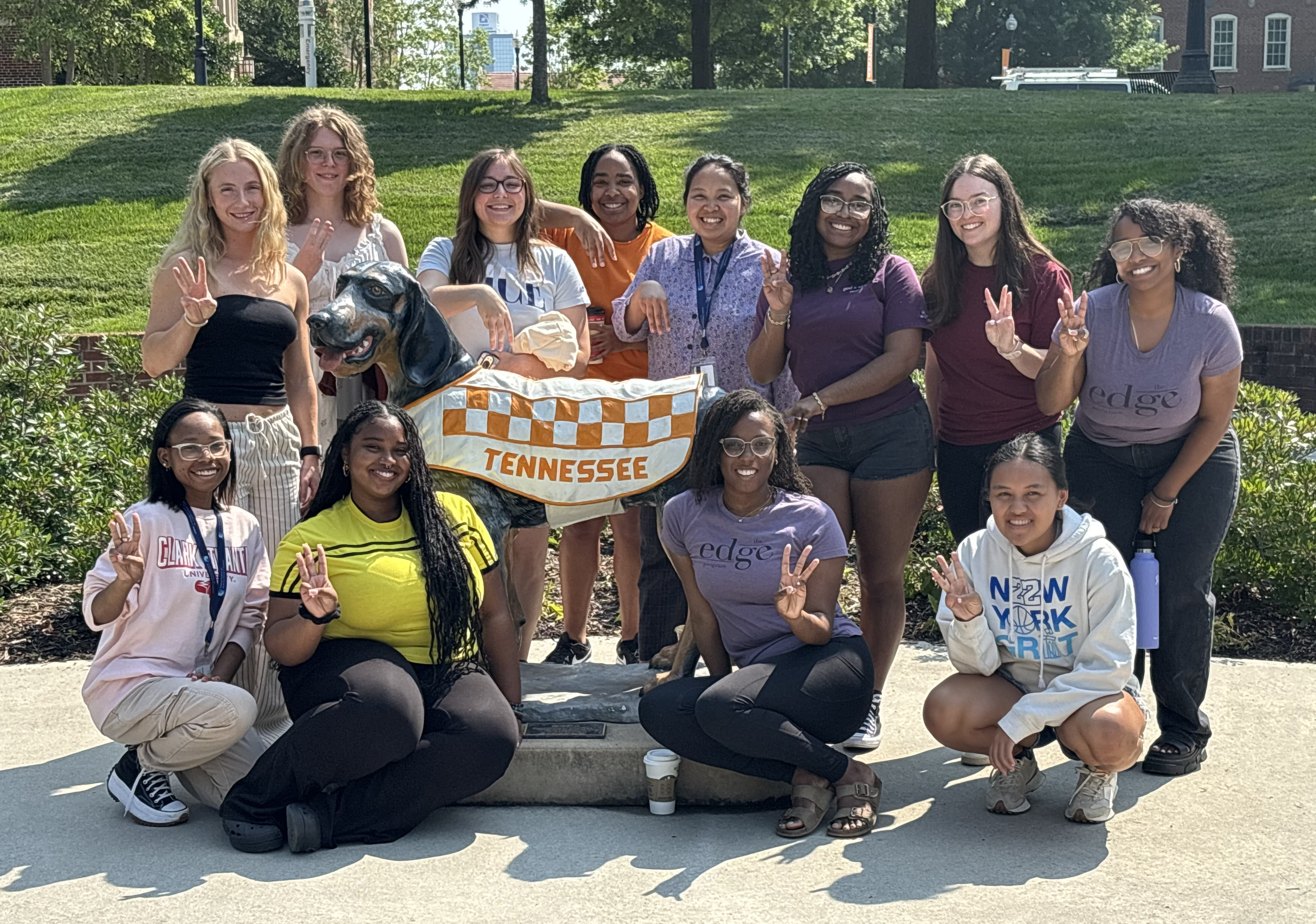 Student participants and mentors of the 2025 Enhancing Diversity in Graduate Education Summer Program—which was held in June at the University of Tennessee, Knoxville—explore campus during a daily walk and gather for a group photo with Smokey, the official mascot of the university. Author Cheyene Henry is second from left in the bottom row. Photo courtesy of the author.