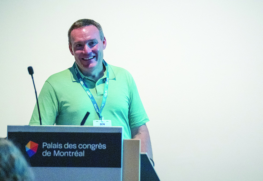 At the Third Joint SIAM/CAIMS Annual Meetings, which took place last summer in Montréal, Québec, Canada, Benjamin Galluzzo of the Consortium for Mathematics and Its Applications (COMAP) discusses two different COMAP middle and high school mathematical modeling contests during a minisymposium session that addressed the importance of community engagement in mathematics. SIAM photo.