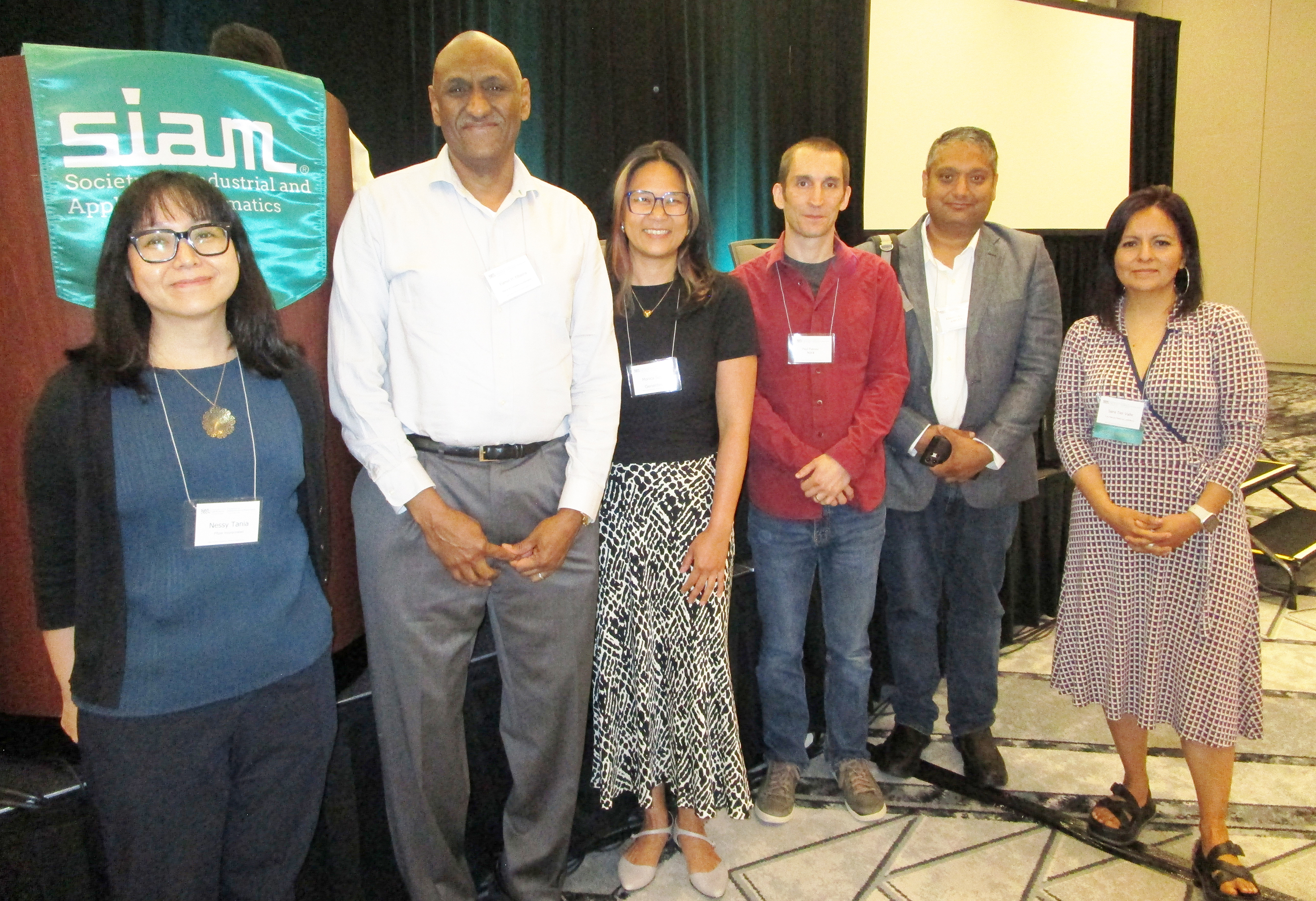 During a panel discussion at the 2024 SIAM Conference on the Life Sciences, which took place in June in Portland, Ore., researchers from industry and government settings commented on their respective experiences with mathematical careers in the life sciences and fielded questions from the audience. From left to right: moderator Nessy Tania of Pfizer and panelists Elamin Elbasha of Merck &amp; Co., Monica Susilo of Genentech, Paul Patrone of the National Institute of Standards and Technology, Khamir Mehta of Amgen, and Sara Del Valle of Los Alamos National Laboratory. SIAM photo.